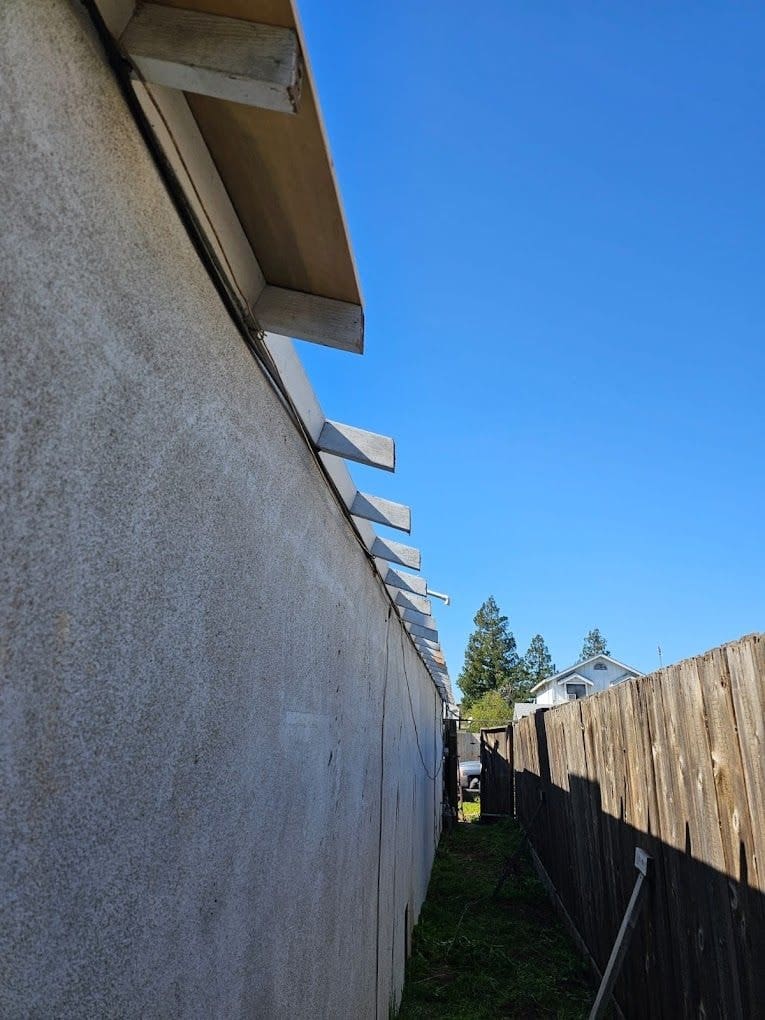 Restored eave line with new rafter tails along a side yard