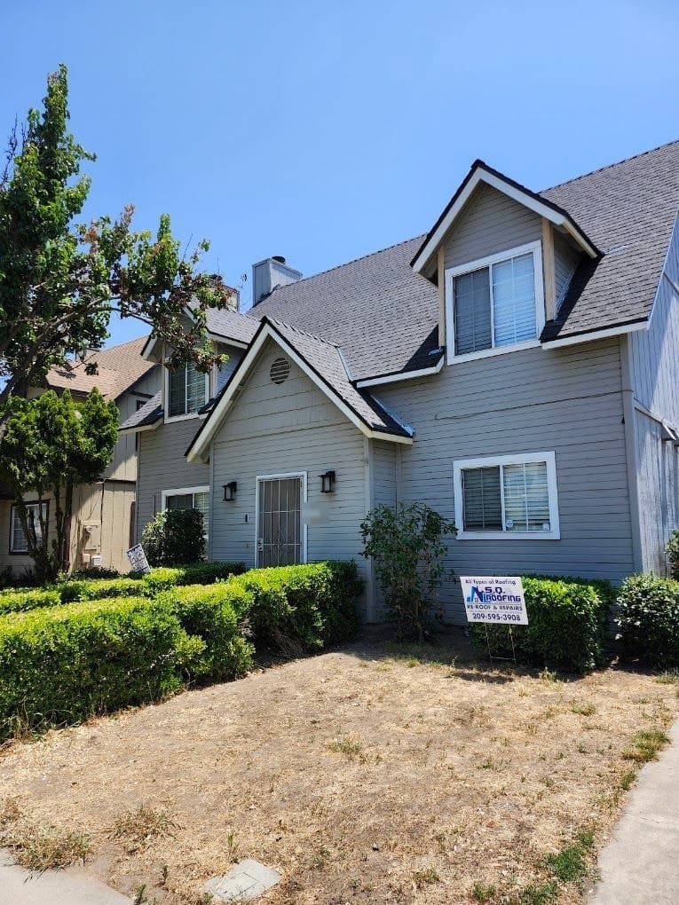 Completed shingle roof on a two-story home