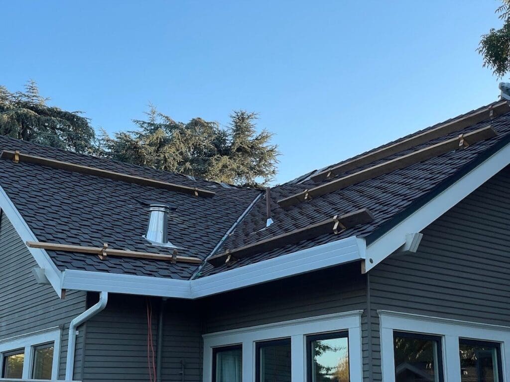 New shingles being installed on a two-story home