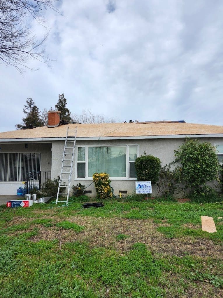 Single-story home during a roof tear-off and re-roof