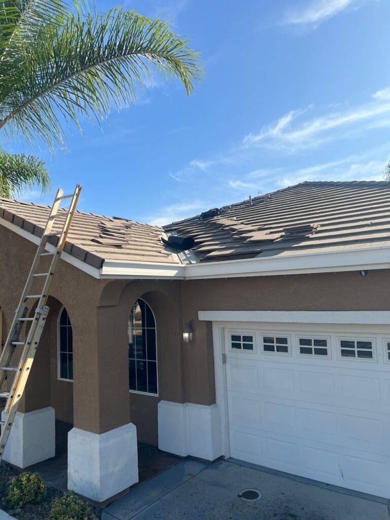 Ladder set up for valley cleaning on a tile roof